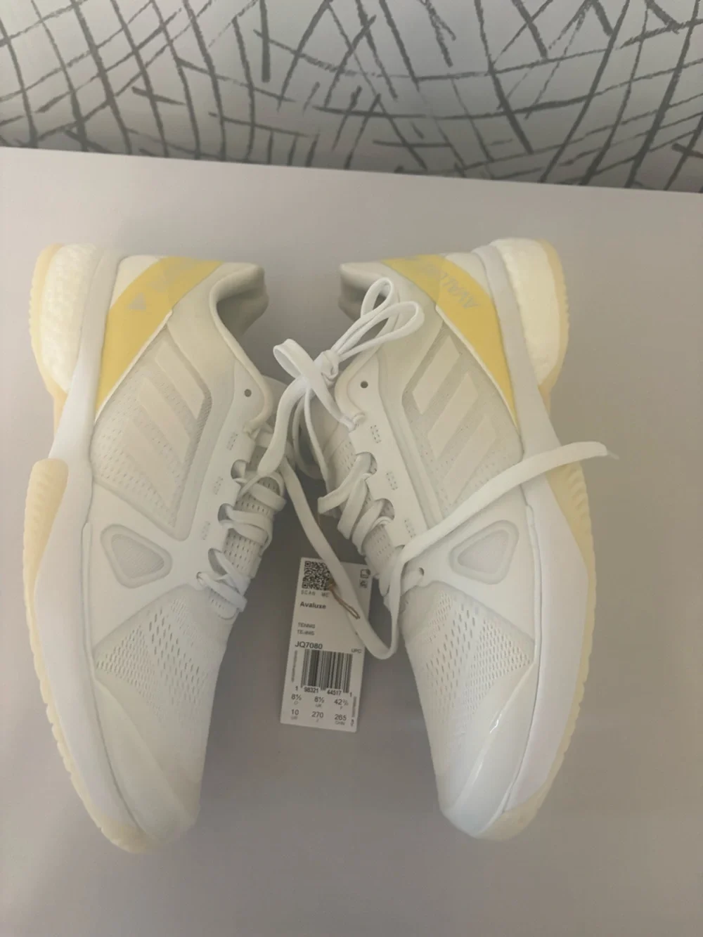 adidas Avaluxe tennis shoes in white with subtle pastel yellow accents. JQ7080